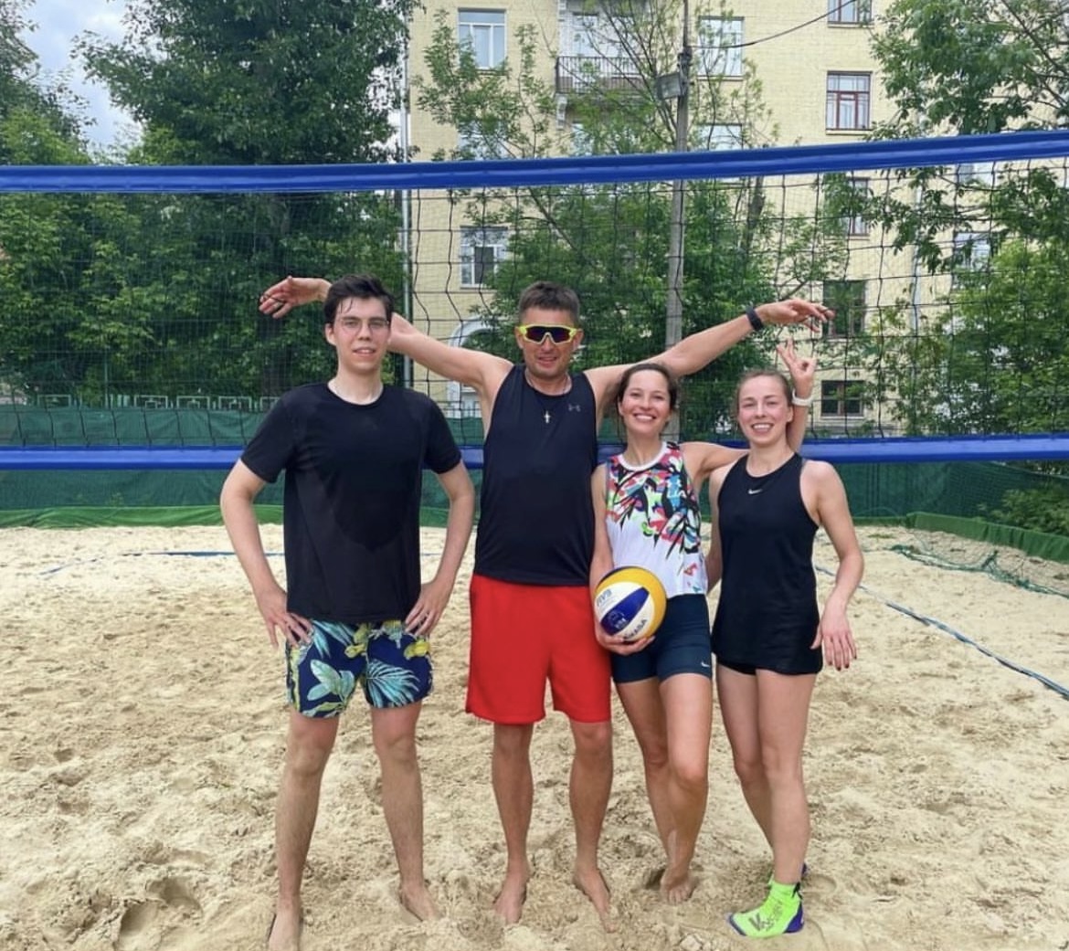 Nikita and friends on a beach volleyball court